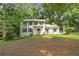 Exterior view of a home with a well-manicured lawn and mature trees surrounding the property at 2935 Leafwood Se Dr, Marietta, GA 30067