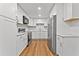 Well-lit kitchen with stainless steel appliances, white cabinets, and hardwood floors at 2935 Leafwood Se Dr, Marietta, GA 30067