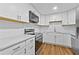 Bright kitchen boasts updated appliances, white cabinets, and elegant countertops at 2935 Leafwood Se Dr, Marietta, GA 30067