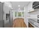 Eat-in kitchen featuring stainless steel appliances, white cabinetry and views of the backyard at 2935 Leafwood Se Dr, Marietta, GA 30067