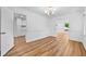 Open living room with hardwood flooring, neutral paint, and a modern chandelier at 2935 Leafwood Se Dr, Marietta, GA 30067
