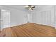 Expansive main bedroom with wood-look floors, neutral paint, a ceiling fan, an attached closet and bath at 2935 Leafwood Se Dr, Marietta, GA 30067