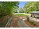 Community pool area with lawn chairs and umbrellas surrounded by trees at 2935 Leafwood Se Dr, Marietta, GA 30067