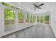 Bright sunroom with tile floors, ceiling fan, and lots of natural light from surrounding windows at 2935 Leafwood Se Dr, Marietta, GA 30067