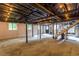 Partially finished basement featuring exposed beams and string lights at 6715 Wright Rd, Sandy Springs, GA 30328