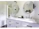 Bright bathroom features double vanity, marble countertop, and stylish oval mirrors at 6715 Wright Rd, Sandy Springs, GA 30328