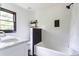 Bright bathroom features a tub/shower combo with white subway tile, black accent tiles, and a large window at 6715 Wright Rd, Sandy Springs, GA 30328