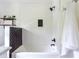 Bright bathroom features a tub/shower combo with white subway tile, black accent tiles, and open shelving at 6715 Wright Rd, Sandy Springs, GA 30328