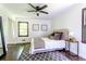 Bright bedroom features dark hardwood floors, large windows, ceiling fan, and a gray and white color scheme at 6715 Wright Rd, Sandy Springs, GA 30328
