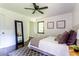 Bright bedroom features dark hardwood floors, large windows, ceiling fan, and a gray and white color scheme at 6715 Wright Rd, Sandy Springs, GA 30328