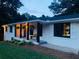 Charming brick home featuring a covered front porch with hanging ferns and stylish accents at 6715 Wright Rd, Sandy Springs, GA 30328