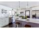 Modern kitchen with white cabinetry, stainless steel appliances, marble counters, and breakfast bar at 6715 Wright Rd, Sandy Springs, GA 30328