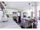 Bright kitchen featuring island with seating, stainless appliances, and stylish pendant lighting at 6715 Wright Rd, Sandy Springs, GA 30328