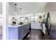 Bright kitchen featuring island with seating, stainless appliances, and stylish pendant lighting at 6715 Wright Rd, Sandy Springs, GA 30328