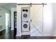 Conveniently located, stacked washer and dryer with sliding barn door off of the living room at 6715 Wright Rd, Sandy Springs, GA 30328
