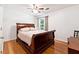 Bedroom featuring a vintage style sleigh bed, hardwood floors, and natural light at 4031 E Meadow Dr, Duluth, GA 30096