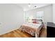 Cozy bedroom with laminate flooring, natural light, and neutral decor at 4031 E Meadow Dr, Duluth, GA 30096