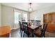 Traditional dining room with a dark wood table set, ample seating, and a window at 4031 E Meadow Dr, Duluth, GA 30096