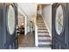 Inviting entryway showcasing tiled floors, staircase, and decorative glass front doors at 4031 E Meadow Dr, Duluth, GA 30096