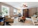 Cozy living room with neutral tones, large windows, and comfortable seating area at 4031 E Meadow Dr, Duluth, GA 30096