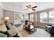 Comfortable living room area featuring stylish decor, natural light, and a ceiling fan at 4031 E Meadow Dr, Duluth, GA 30096