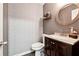 Cozy powder room with a modern vanity, round mirror, stylish wallpaper, and updated fixtures at 4031 E Meadow Dr, Duluth, GA 30096