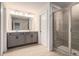 Bright bathroom with dual vanity, tile flooring, and glass shower at 4627 Piston Sw Jct, Mableton, GA 30126