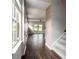 Inviting hallway with dark hardwood floors leads to a bright living area with large windows at 4627 Piston Sw Jct, Mableton, GA 30126
