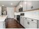 Well-equipped kitchen with modern stainless steel appliances, gray cabinets, subway tile and hardwood floors at 4627 Piston Sw Jct, Mableton, GA 30126