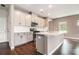 Well-appointed kitchen featuring gray cabinets, quartz countertops, stainless steel appliances and hardwood floors at 4627 Piston Sw Jct, Mableton, GA 30126