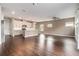 Spacious open-concept living room and kitchen area with hardwood floors and ample natural light at 4627 Piston Sw Jct, Mableton, GA 30126