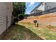 The backyard has tiered retaining walls and a well-manicured lawn at 5414 Sycamore Rd, Oakwood, GA 30518