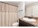 Bathroom featuring a shower with a decorative curtain and a dark wood vanity with a granite countertop at 5414 Sycamore Rd, Oakwood, GA 30518