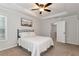 This cozy bedroom has a ceiling fan and a tray ceiling with an ensuite entrance at 5414 Sycamore Rd, Oakwood, GA 30518