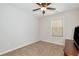Carpeted bedroom featuring a ceiling fan and a window with a wood dresser at 5414 Sycamore Rd, Oakwood, GA 30518