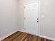 Clean white door in a freshly painted room with modern laminate flooring at 5414 Sycamore Rd, Oakwood, GA 30518