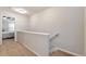 Hallway with carpeted floors leading to a bedroom with a ceiling fan and neutral color palette at 5414 Sycamore Rd, Oakwood, GA 30518