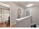 Hallway with views of a bathroom and laundry area with white walls and modern fixtures at 5414 Sycamore Rd, Oakwood, GA 30518