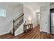 Welcoming hallway with hardwood floors, staircase and neutral paint at 5414 Sycamore Rd, Oakwood, GA 30518