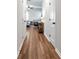 Bright hallway with wood-look flooring leading to a sunlit living area at 5414 Sycamore Rd, Oakwood, GA 30518