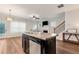 Open-concept kitchen island with sink and dishwasher, leading to the living area at 5414 Sycamore Rd, Oakwood, GA 30518