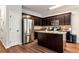 Modern kitchen featuring dark cabinets, stainless steel appliances, and a center island at 5414 Sycamore Rd, Oakwood, GA 30518