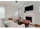 Comfortable living room featuring a fireplace and plenty of natural light from windows at 5414 Sycamore Rd, Oakwood, GA 30518