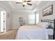 Spacious main bedroom featuring a tray ceiling, fan, and a large window, creating a serene and comfortable retreat at 5414 Sycamore Rd, Oakwood, GA 30518