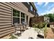 A backyard patio has seating for outdoor dining and entertaining at 5414 Sycamore Rd, Oakwood, GA 30518