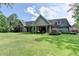 Expansive backyard of a single-Gathering home featuring a large lawn and mature trees at 1168 Atcheson Ln, Atlanta, GA 30338