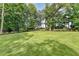 Expansive and lush backyard featuring a well-manicured lawn and mature trees, providing privacy at 1168 Atcheson Ln, Atlanta, GA 30338