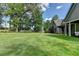 Spacious backyard featuring a lush lawn, mature trees, and a well-maintained fence at 1168 Atcheson Ln, Atlanta, GA 30338