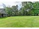 Spacious and lush backyard featuring a well-manicured lawn and mature trees, providing privacy at 1168 Atcheson Ln, Atlanta, GA 30338