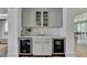 Convenient bar area with storage cabinets, countertop space, and dual mini fridge units at 1168 Atcheson Ln, Atlanta, GA 30338
